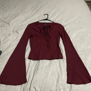 Burgundy long sleeved cropped shirt.